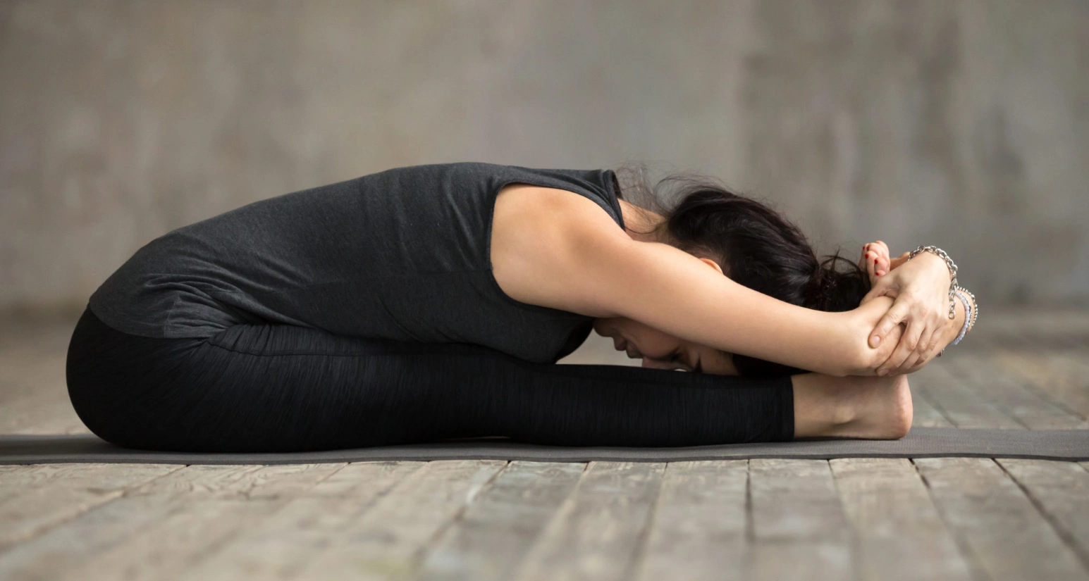 girl doing Seated Forward Bend-Paschimottanasana